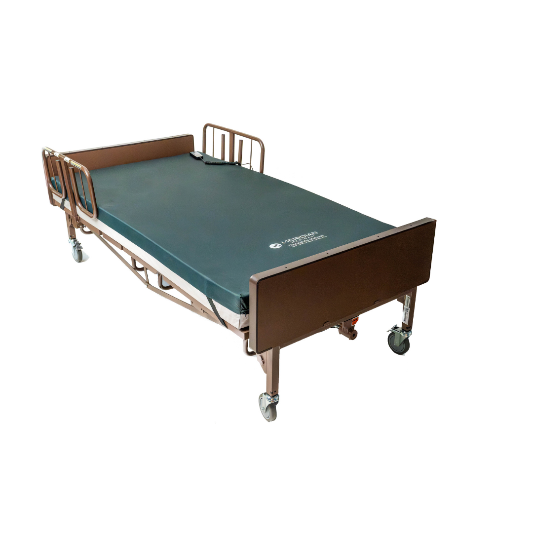 The ProBasics 42 Bariatric Full Electric Homecare Bed is shown on a plain white background, featuring a dark green mattress, brown frame, side rails, and wheels on each leg.